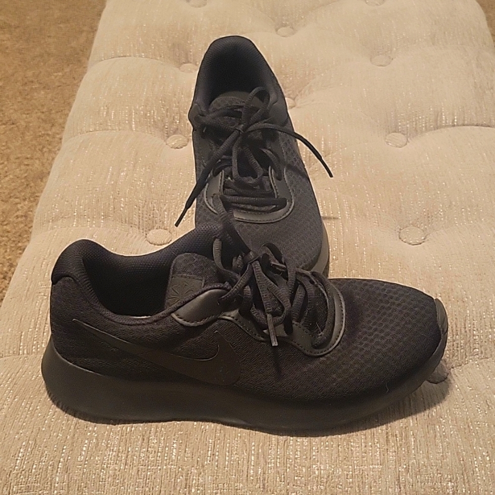 Solid black NIKE athletic shoes
